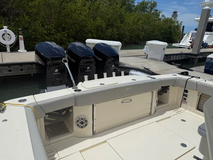 Yacht Photos Pics 2022 Scout 425 LXF boat with triple outboard engines docked at marina.