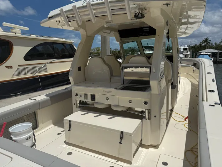  Yacht Photos Pics 2022 Scout 425 LXF boat interior with seating and storage, docked under a clear sky.