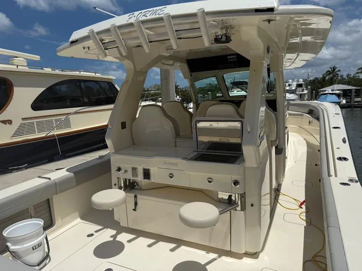  Yacht Photos Pics 2022 Scout 425 LXF boat with seating and fishing amenities, docked at a marina.