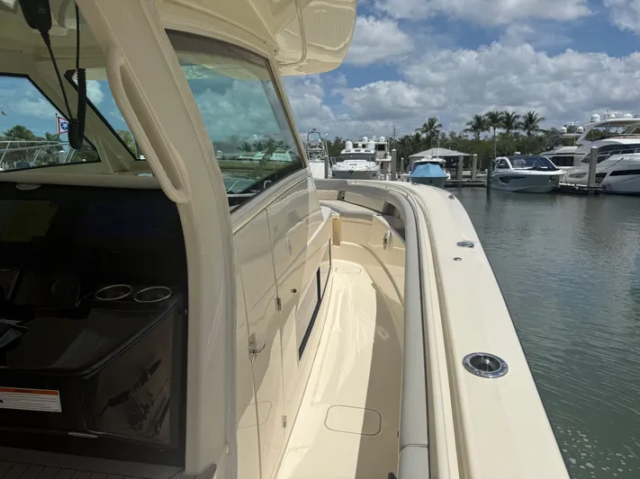  Yacht Photos Pics 2022 Scout 425 LXF boat docked at marina under blue sky.