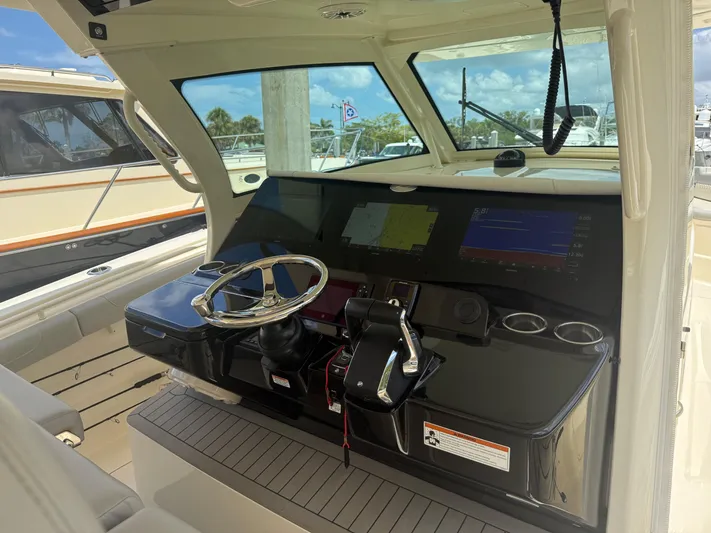  Yacht Photos Pics 2022 Scout 425 LXF boat helm with modern controls and navigation screens.