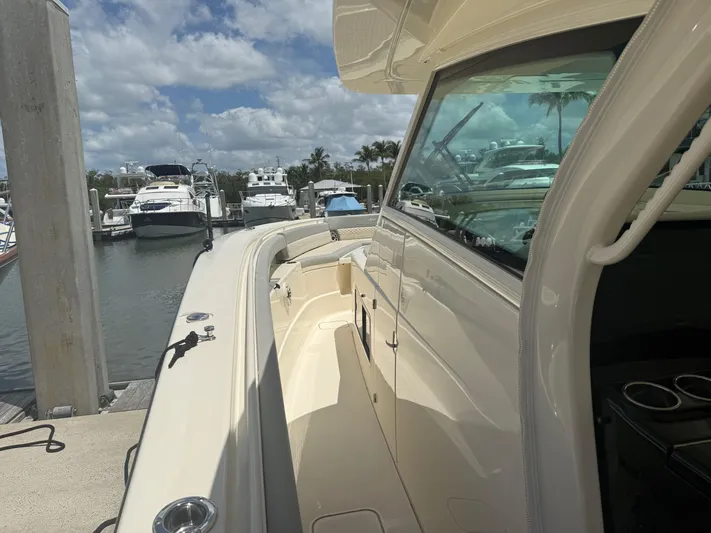  Yacht Photos Pics 2022 Scout 425 LXF boat docked at marina, showcasing sleek design and spacious deck.