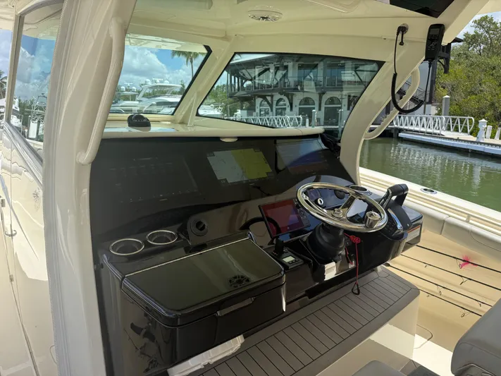  Yacht Photos Pics 2022 Scout 425 LXF boat cockpit with modern controls and steering wheel.