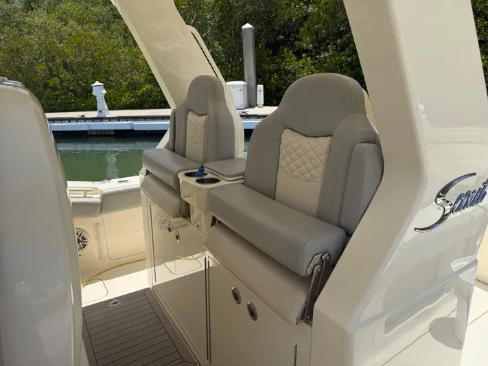  Yacht Photos Pics 2022 Scout 425 LXF boat seats with elegant design and waterfront view.