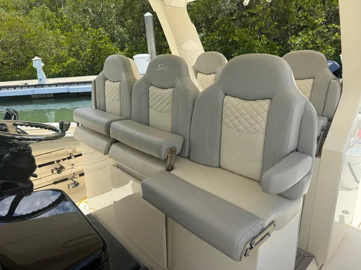  Yacht Photos Pics Luxurious seating on 2022 Scout 425 LXF boat, featuring elegant gray upholstery.