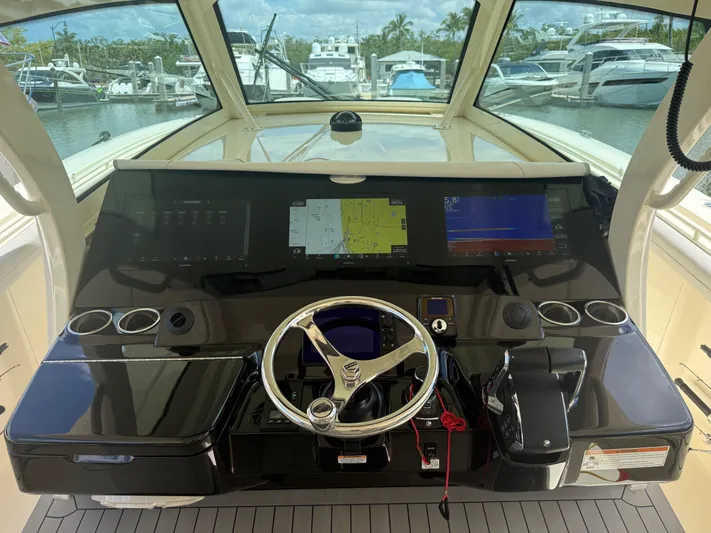  Yacht Photos Pics Helm of 2022 Scout 425 LXF boat with advanced navigation displays and steering wheel.