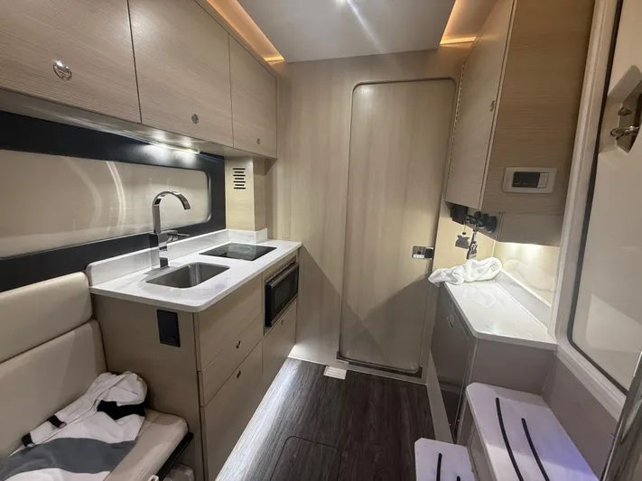  Yacht Photos Pics Luxurious interior of 2022 Scout 425 LXF boat featuring modern kitchen amenities.