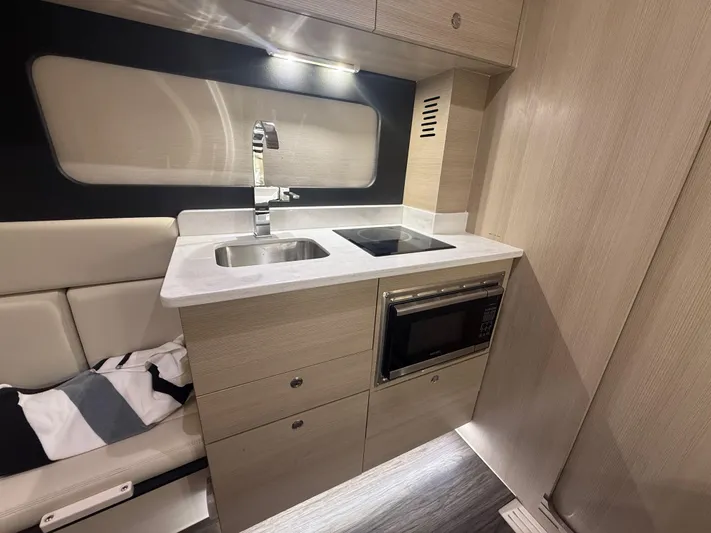  Yacht Photos Pics 2022 Scout 425 LXF interior kitchen with sink, stove, and microwave.