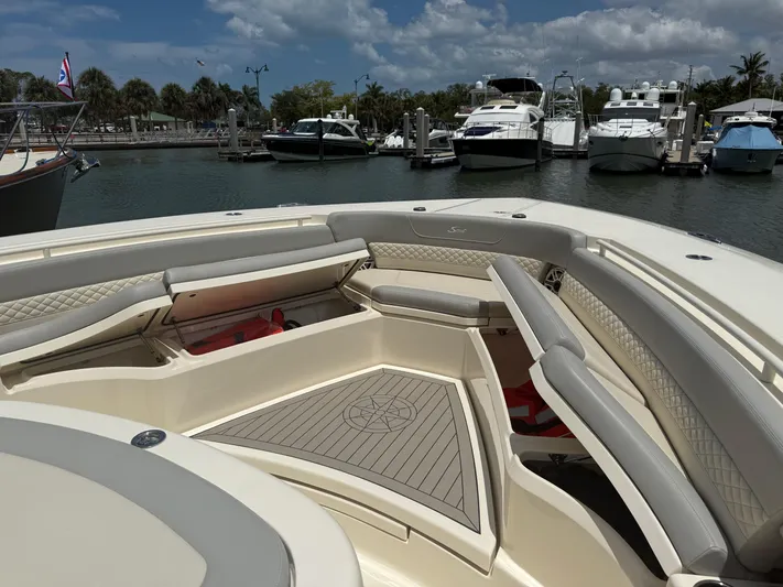  Yacht Photos Pics Luxurious 2022 Scout 425 LXF boat interior at marina, featuring elegant seating and spacious deck.