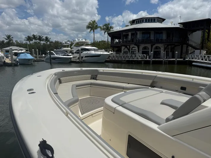  Yacht Photos Pics 2022 Scout 425 LXF boat docked at marina with luxury yachts and palm trees.