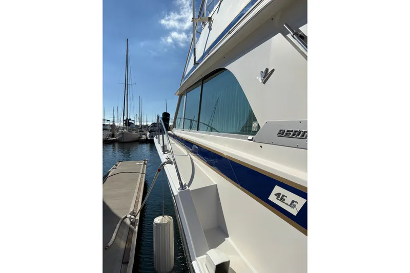 Sea Legs Yacht Photos Pics 1987 Bertram 46.6 yacht docked at marina under clear blue sky.