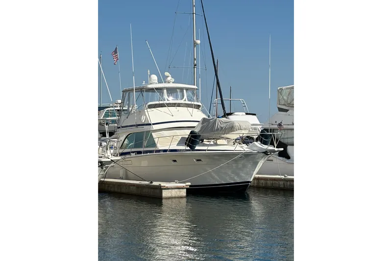 Sea Legs Yacht Photos Pics 1987 Bertram 46.6 yacht docked at marina under clear blue sky.