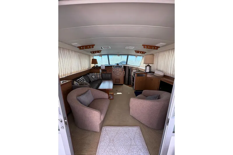 Sea Legs Yacht Photos Pics Interior of 1987 Bertram 46.6 yacht with cozy seating and helm view.