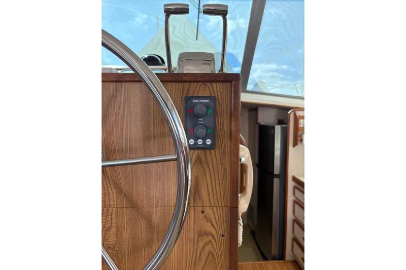 Sea Legs Yacht Photos Pics 1987 Bertram 46.6 yacht helm with wooden panel and steering wheel.