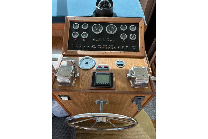 Sea Legs Yacht Photos Pics 1987 Bertram 46.6 yacht helm with gauges, controls, and steering wheel.