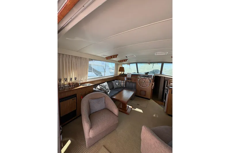 Sea Legs Yacht Photos Pics Interior of 1987 Bertram 46.6 yacht with cozy seating and wooden accents.