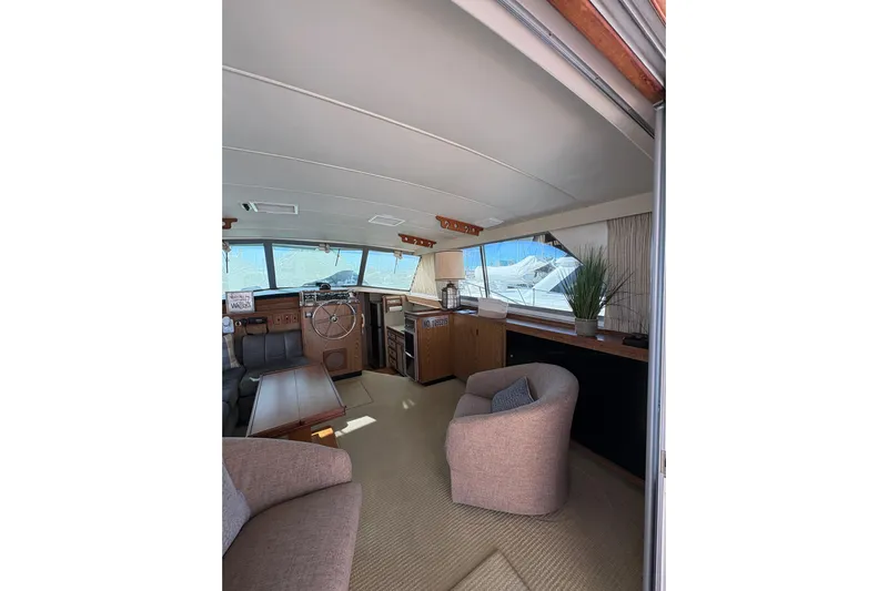 Sea Legs Yacht Photos Pics Interior of 1987 Bertram 46.6 yacht with helm, seating, and decor elements.