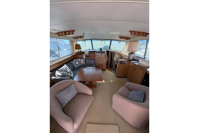 Sea Legs Yacht Photos Pics Interior of 1987 Bertram 46.6 yacht with cozy seating and nautical decor.