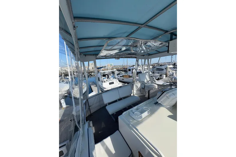 Sea Legs Yacht Photos Pics 1987 Bertram 46.6 yacht interior with blue canopy, docked at marina.