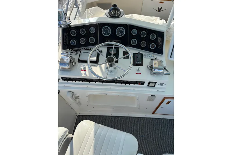 Sea Legs Yacht Photos Pics Control panel of a 1987 Bertram 46.6 yacht with steering wheel and gauges.