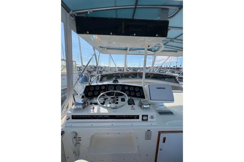 Sea Legs Yacht Photos Pics Cockpit of 1987 Bertram 46.6 yacht with steering wheel and navigation equipment.