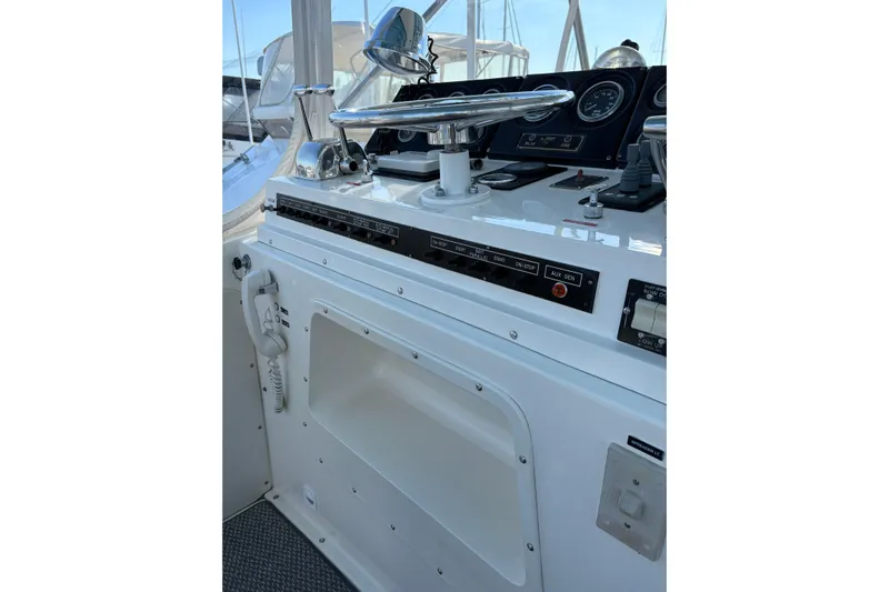 Sea Legs Yacht Photos Pics Control panel of a 1987 Bertram 46.6 yacht, featuring steering and navigation instruments.