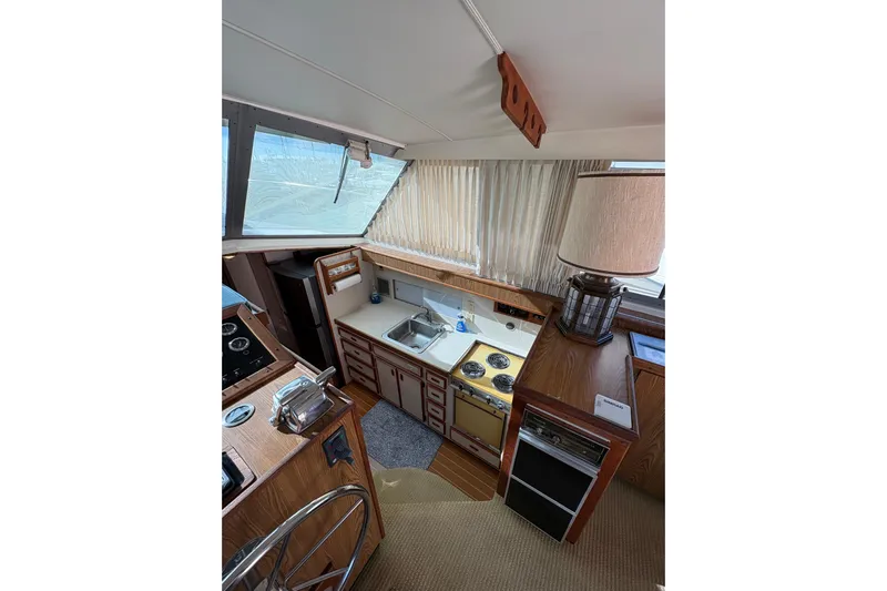 Sea Legs Yacht Photos Pics Interior of 1987 Bertram 46.6 yacht with kitchen and steering area.