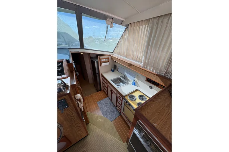 Sea Legs Yacht Photos Pics Interior of 1987 Bertram 46.6 yacht with kitchen and wooden cabinetry.