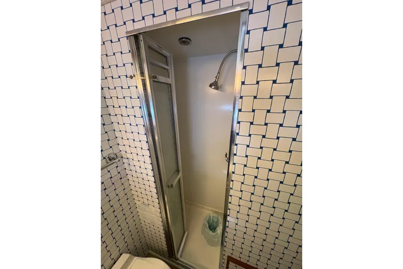 Sea Legs Yacht Photos Pics Compact shower in 1987 Bertram 46.6 yacht with geometric tiled walls.