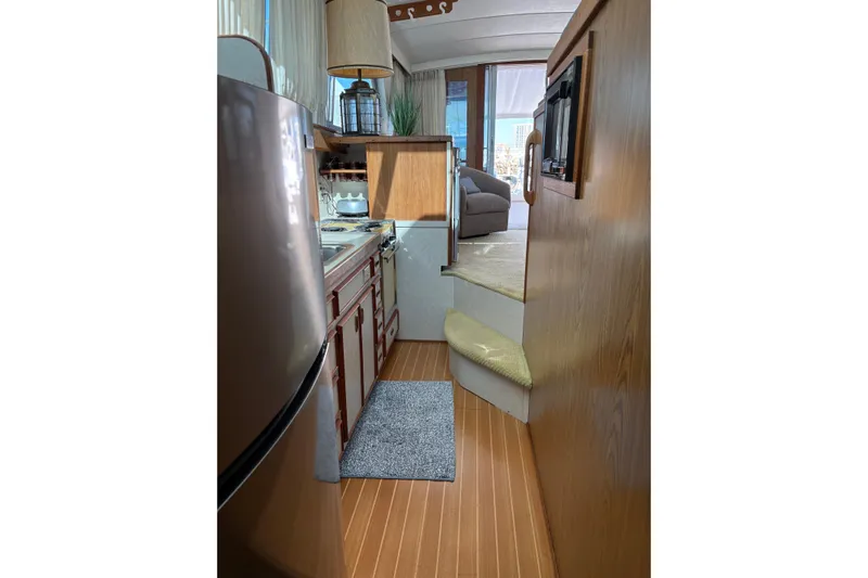 Sea Legs Yacht Photos Pics Interior of 1987 Bertram 46.6 yacht, featuring a compact kitchen and cozy living area.