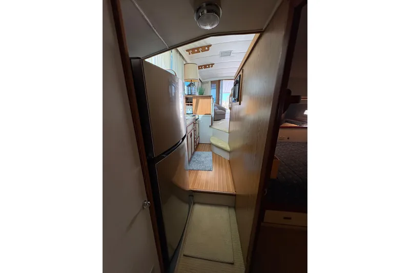 Sea Legs Yacht Photos Pics Interior view of 1987 Bertram 46.6 yacht, featuring kitchen and living area.