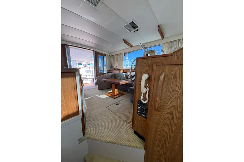Sea Legs Yacht Photos Pics Interior of 1987 Bertram 46.6 yacht with wood paneling and seating area.