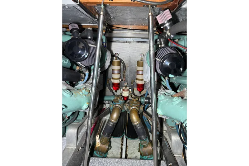 Sea Legs Yacht Photos Pics Engine room of a 1987 Bertram 46.6 yacht, showcasing mechanical components and filters.