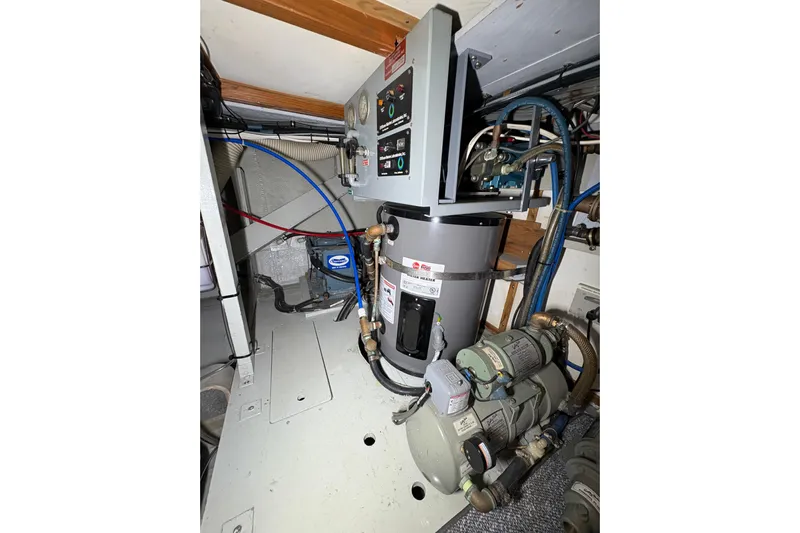 Sea Legs Yacht Photos Pics Engine room of 1987 Bertram 46.6 yacht with water heater and machinery.