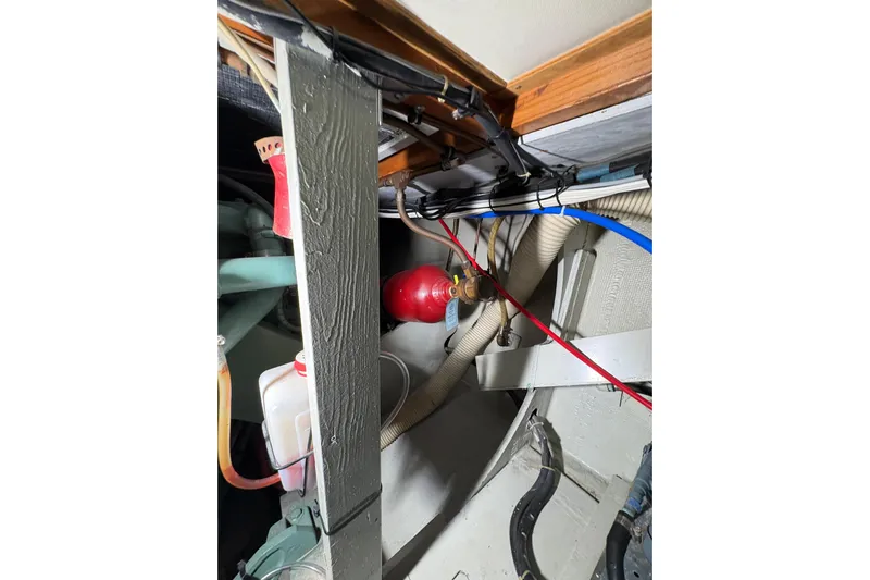 Sea Legs Yacht Photos Pics Engine room of a 1987 Bertram 46.6 yacht, showing hoses and equipment.