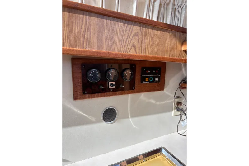 Sea Legs Yacht Photos Pics Control panel on a 1987 Bertram 46.6 yacht with wood finish and gauges.