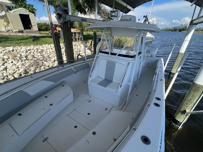  Yacht Photos Pics 2008 Fountain 34 CC boat docked by a serene lakeside.