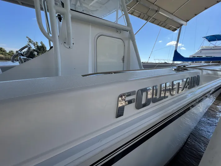  Yacht Photos Pics 2008 Fountain 34 CC boat docked, showcasing sleek design and branding.