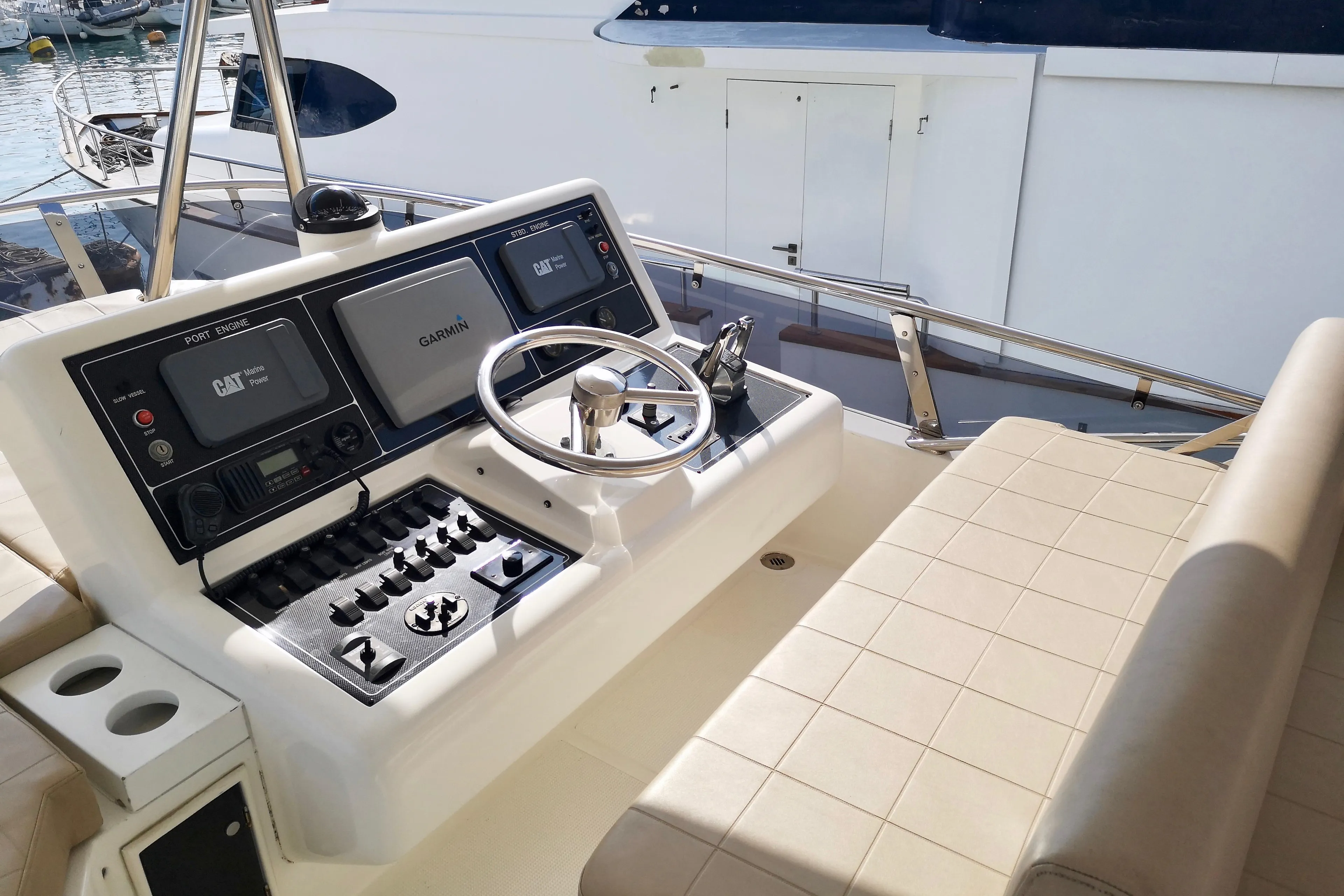 Control panel of a 2012 Ruby 65s yacht with steering wheel and navigation equipment.