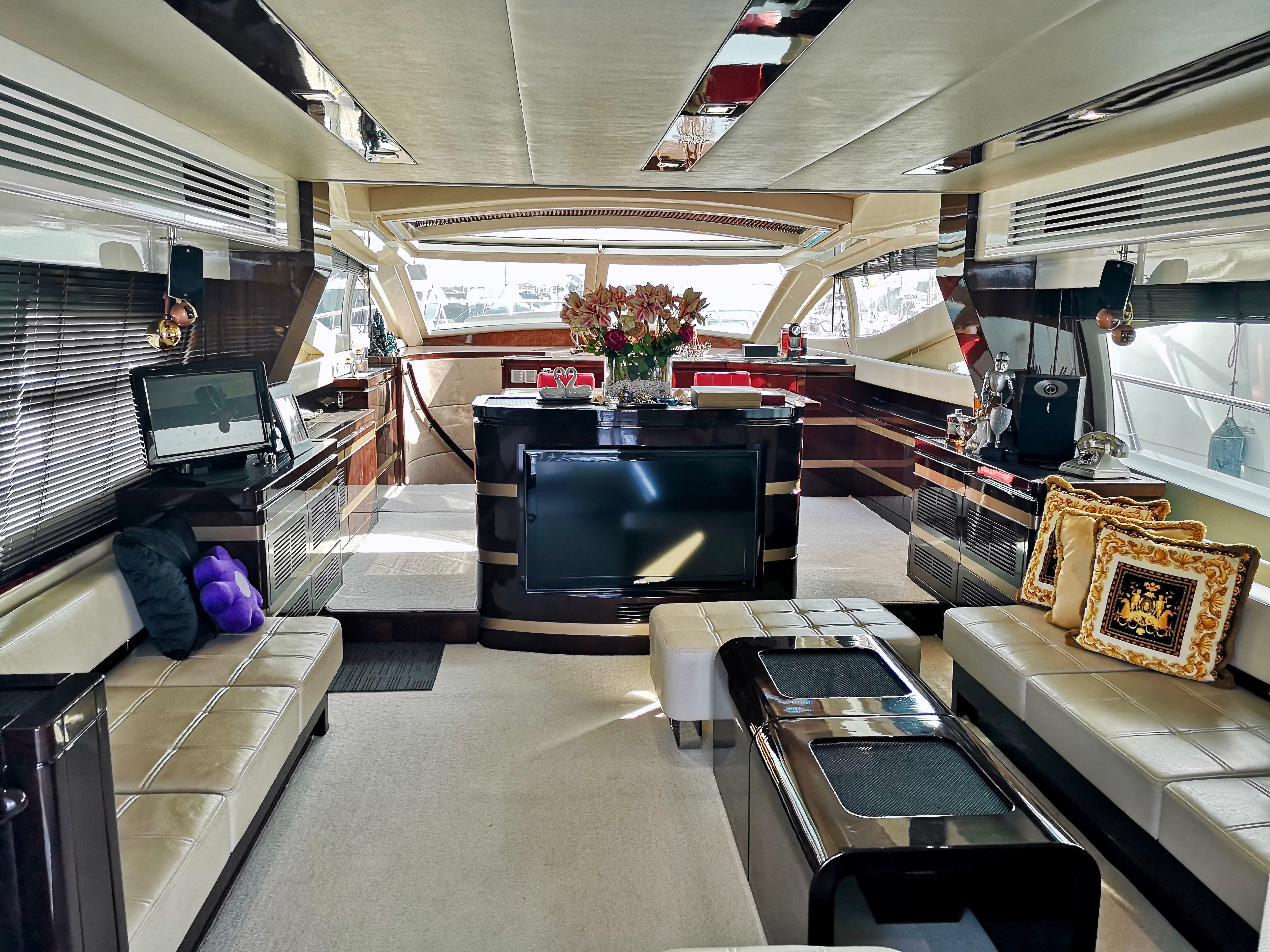Luxurious interior of a 2012 Ruby 65s yacht with elegant seating and modern decor.