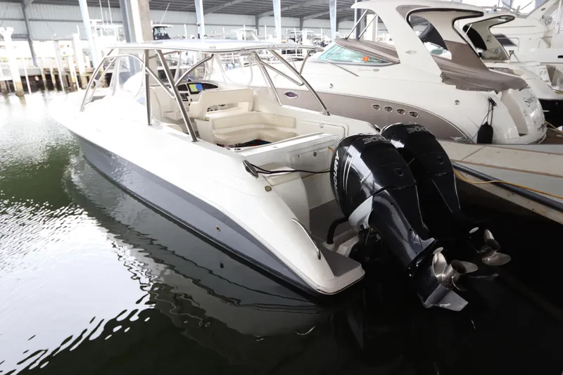  Yacht Photos Pics 2014 Intermarine 380 Sport boat with dual outboard engines docked in marina.