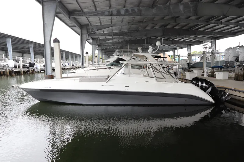  Yacht Photos Pics 2014 Intermarine 380 Sport boat docked under a covered marina.