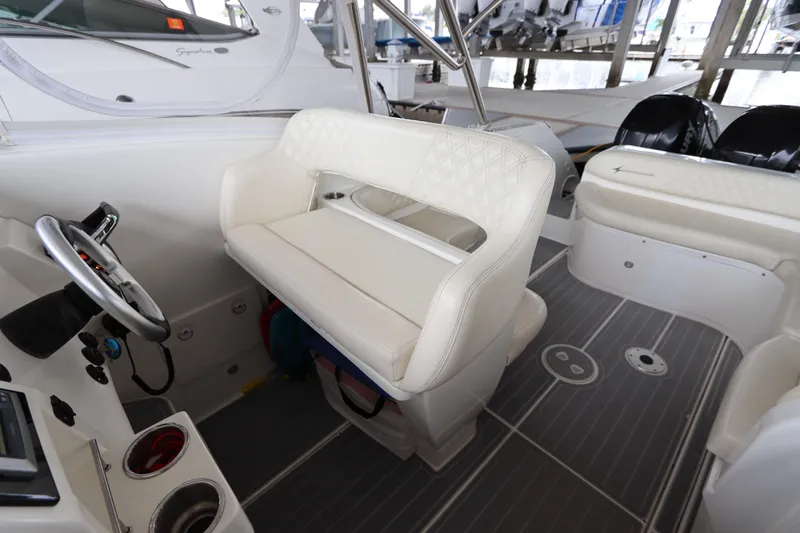  Yacht Photos Pics Interior of a 2014 Intermarine 380 Sport boat with white seating and steering wheel.