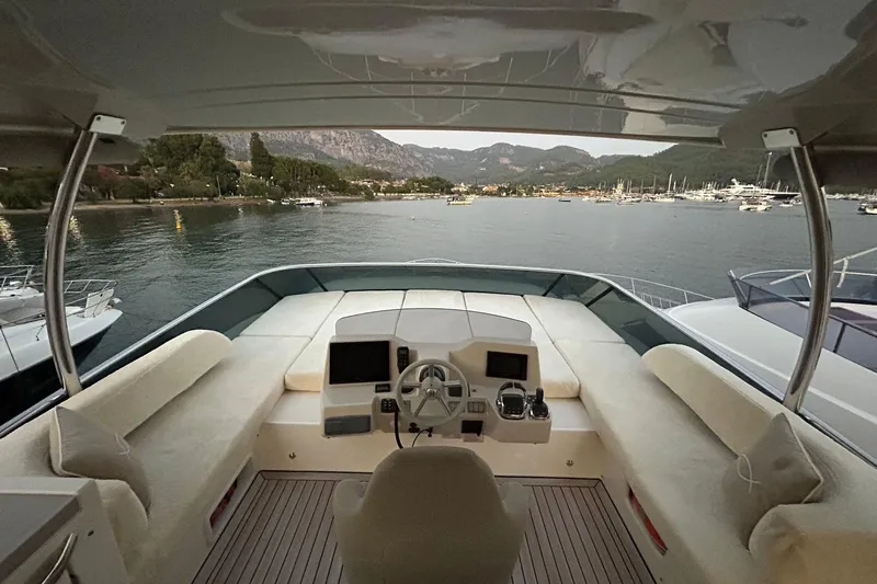 48 Navetta Yacht Photos Pics Cockpit view of 2019 Absolute NAVETTA 48 yacht overlooking serene harbor.