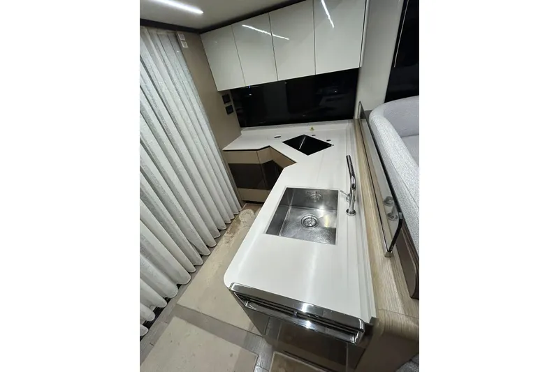 48 Navetta Yacht Photos Pics Modern kitchen interior of 2019 Absolute NAVETTA 48 yacht with sleek countertops and sink.