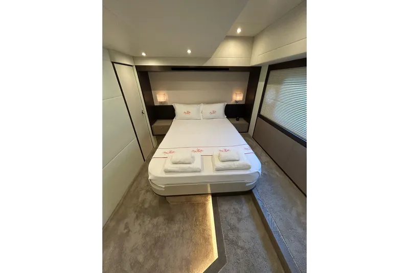 48 Navetta Yacht Photos Pics Luxurious bedroom interior of 2019 Absolute NAVETTA 48 yacht, featuring elegant bedding and ambient lighting.
