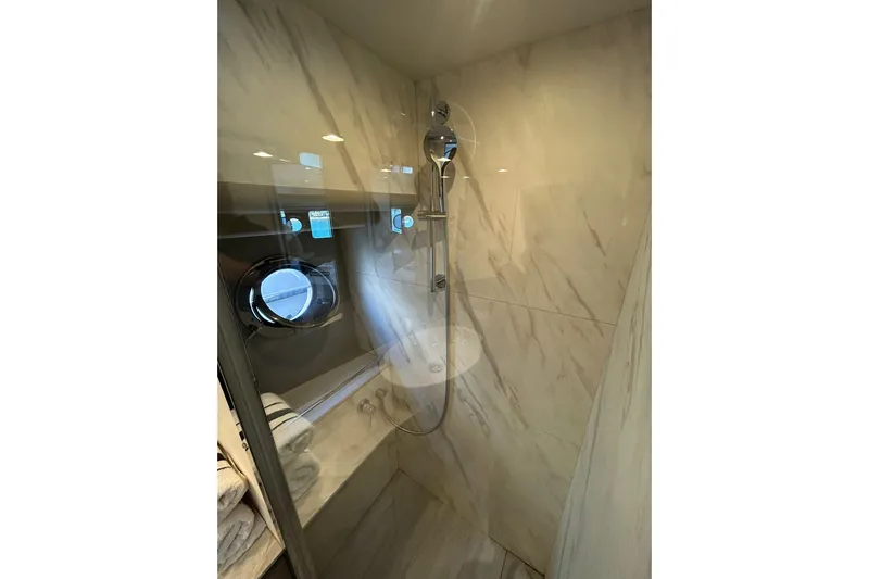48 Navetta Yacht Photos Pics Luxurious shower area in 2019 Absolute NAVETTA 48 yacht with marble walls and porthole window.
