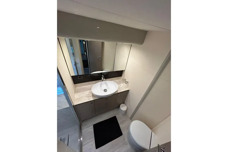 48 Navetta Yacht Photos Pics Luxurious bathroom in 2019 Absolute NAVETTA 48 yacht, featuring modern sink and toilet.