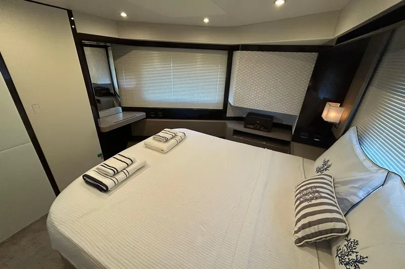 48 Navetta Yacht Photos Pics Luxurious bedroom interior of 2019 Absolute NAVETTA 48 yacht with elegant decor and soft lighting.