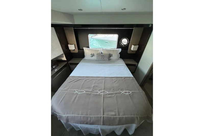 48 Navetta Yacht Photos Pics Luxurious bedroom interior of 2019 Absolute NAVETTA 48 yacht with elegant bedding and window view.